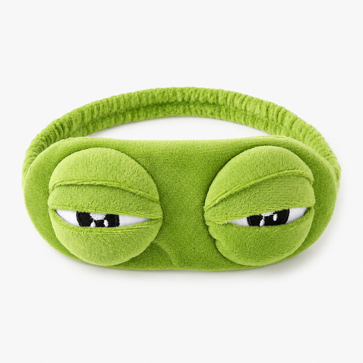Green eye mask with frog design on a white background